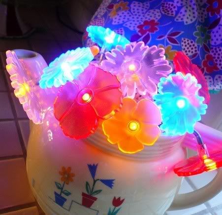 Colorful plastic flowers and teapot